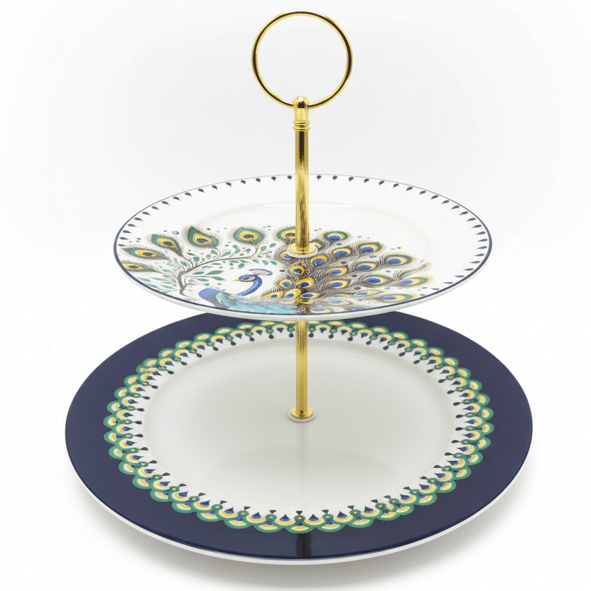 "Elegant two-tiered peacock serving stand with navy blue and white porcelain plates and gold metal stand on white background"