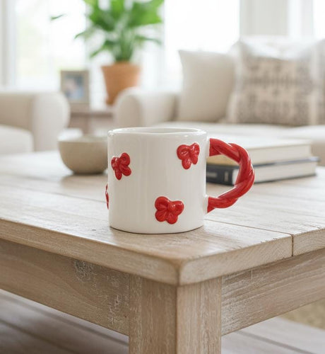 AKDC 400ml White Ceramic Mug with Red Bow Design – Classic, Minimal, and Beautiful for Everyday Enjoyment - Al Kabayel Discount CentreAKDC 400ml White Ceramic Mug with Red Bow Design – Classic, Minimal, and Beautiful for Everyday EnjoymentMugsAKDCAl Kabayel Discount Centre