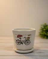 AKDC Compact White Ceramic Pot with Cycle Pattern Artwork – 9×10 cm - Al Kabayel Discount CentreAKDC Compact White Ceramic Pot with Cycle Pattern Artwork – 9×10 cmFlower/Plant PotsAKDCAl Kabayel Discount Centre
