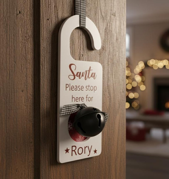 AKDC White “Santa Please Stop Here for Rory” Hanging Décor with Bell – Elegant Christmas Wall Decoration Sign - Al Kabayel Discount CentreAKDC White “Santa Please Stop Here for Rory” Hanging Décor with Bell – Elegant Christmas Wall Decoration SignHome Décor AccentsAKDCAl Kabayel Discount Centre