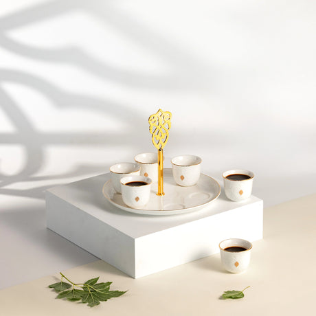 Otantic Naqsh 7pcs Porcelain Arabic Coffee Set, 6pcs Cups 80ml +1pc Standwith Handle, White/Gold, ET2965 - Al Kabayel Discount CentreOtantic Naqsh 7pcs Porcelain Arabic Coffee Set, 6pcs Cups 80ml +1pc Standwith Handle, White/Gold, ET2965Tea SetsOTANTIKAl Kabayel Discount Centre