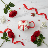 Red Bow Ceramic Mug — Floral Elegance Edition | 300ml - Al Kabayel Discount CentreRed Bow Ceramic Mug — Floral Elegance Edition | 300mlMugsAKDCAl Kabayel Discount Centre