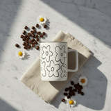 White Ceramic Daisy Flower Mug – 400ml | Black Print & Rim - Al Kabayel Discount CentreWhite Ceramic Daisy Flower Mug – 400ml | Black Print & RimMugsAKDCAl Kabayel Discount Centre